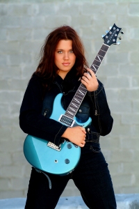 Photograph of a beautiful girl playing the guitar